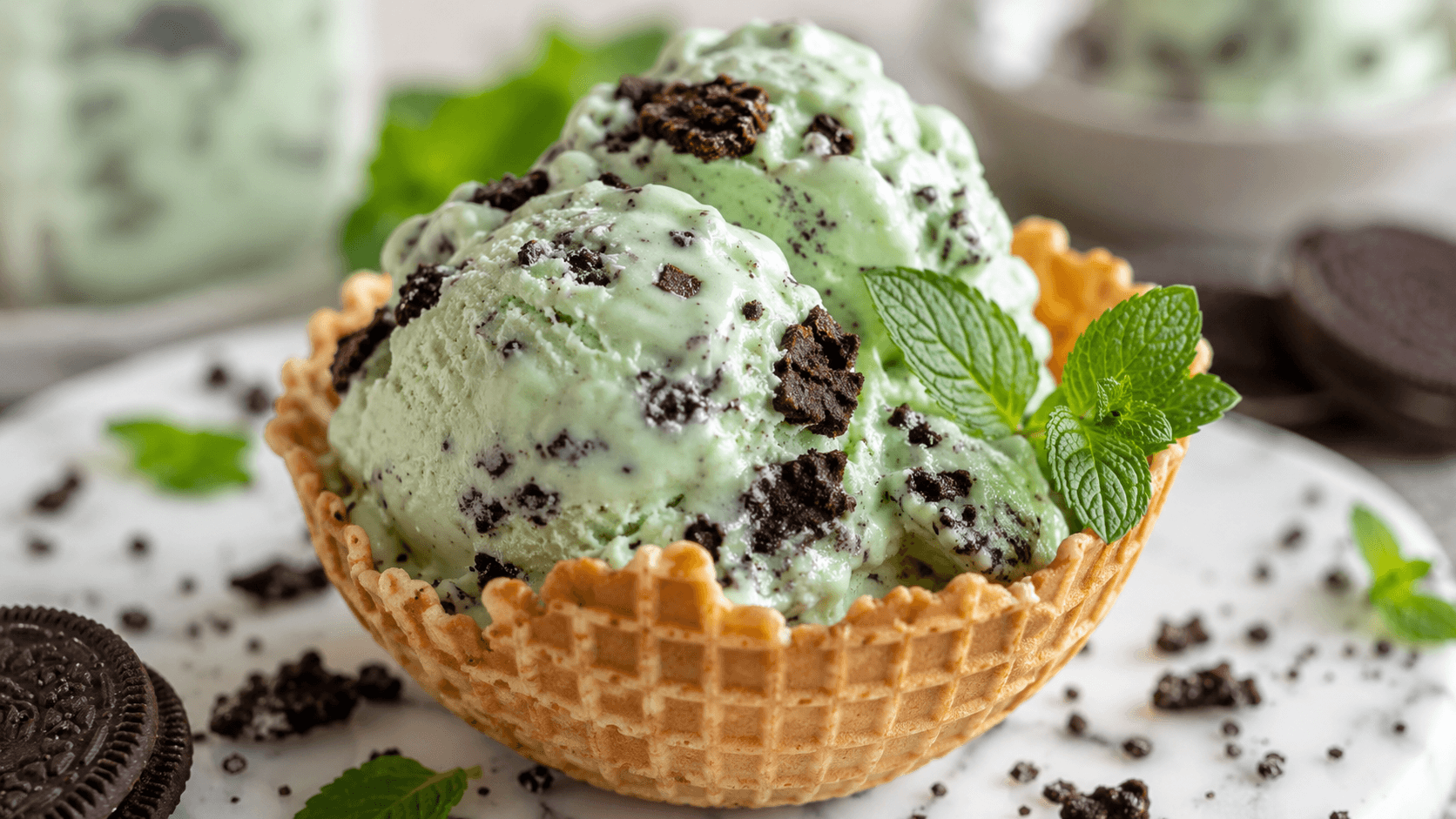 Chocolate mint cookie recipe ice cream served in a waffle bowl with chocolate cookie chunks