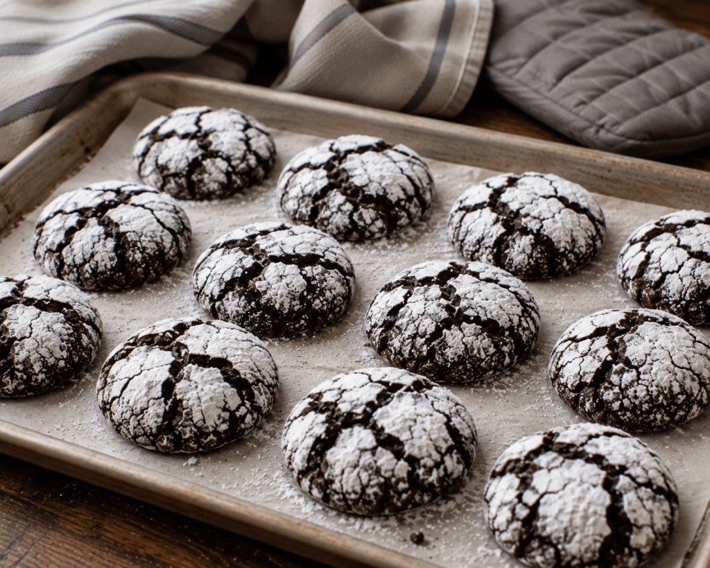 Freshly baked fudgy chocolate crinkle cookies with powdered sugar cracks